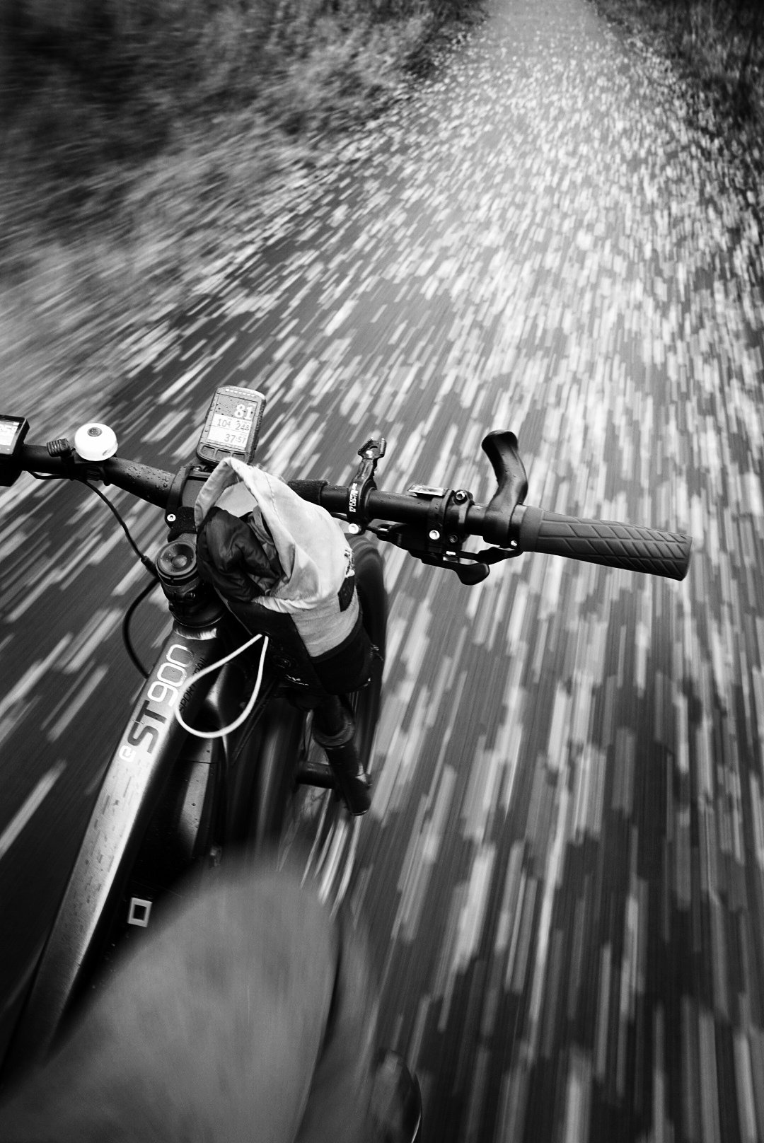 Mountain bike POV shot with motion blur through woodland